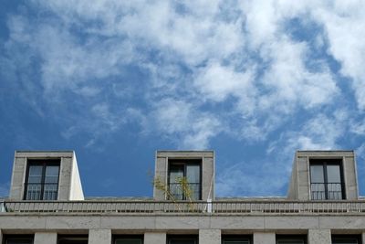 Low angle view of building against cloudy sky