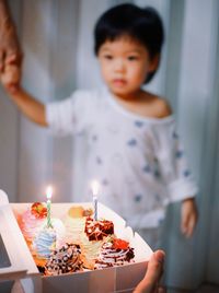Close-up of girl blowing birthday cake