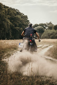 Carefree mature man riding motorcycle on road