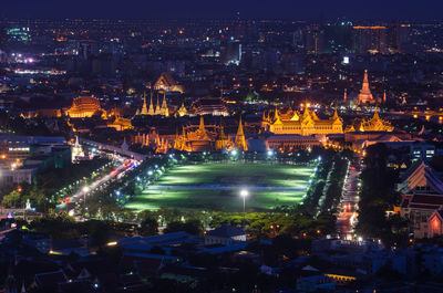 High angle view of city lit up at night