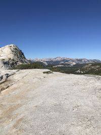 Scenic view of rocky mountains against clear blue sky