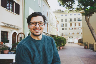 Portrait of smiling young man in city