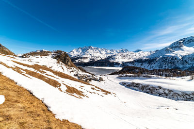 View of the village of grevasalvas, and lake sils, in engadine, switzerland, in winter.