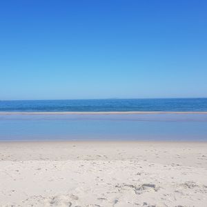 Scenic view of sea against clear blue sky