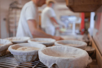 Midsection of man preparing bread