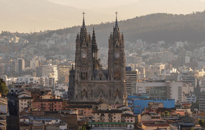 Aerial view of buildings in city against sky