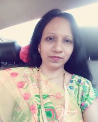 Portrait of smiling young woman in car