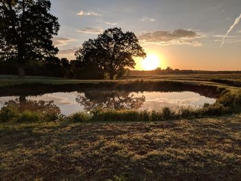 Scenic view of lake against sky during sunset