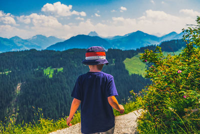 Rear view of boy looking at mountains