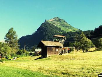 House on landscape against clear sky