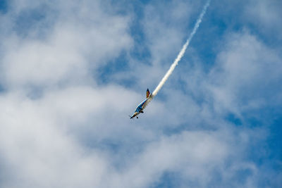 Low angle view of airplane flying in sky