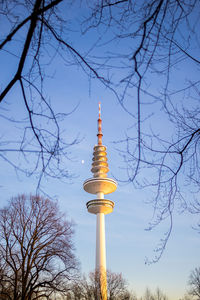 Low angle view of communications tower against sky