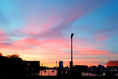 Silhouette of city against dramatic sky