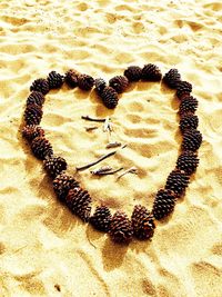 High angle view of heart shape on sand