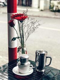 Close-up of red and potted plant on table