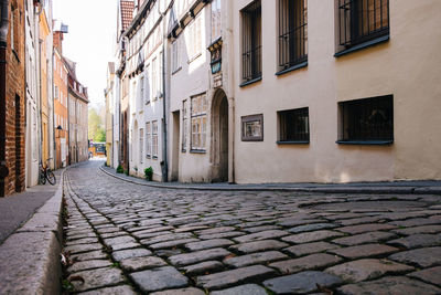 Cobbled street amidst buildings