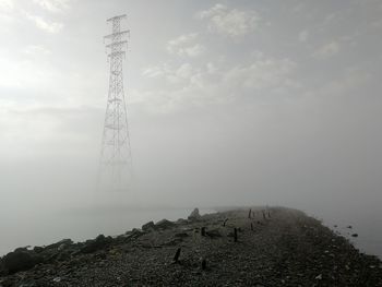 Low angle view of tower on mountain against sky