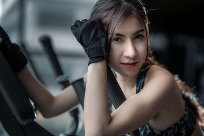 Portrait of young woman sitting outdoors