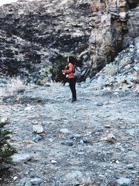 Full length of man standing on rock