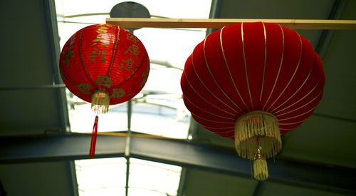 Low angle view of illuminated lanterns hanging from ceiling