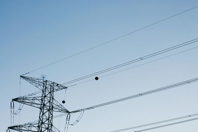 Low angle view of electricity pylon