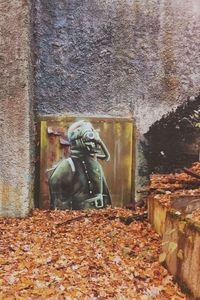 Statue against brick wall