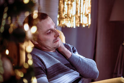 Portrait of man looking away at home