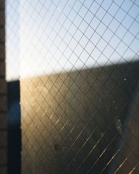 Close-up of chainlink fence against sky