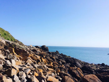 Scenic view of sea against clear blue sky