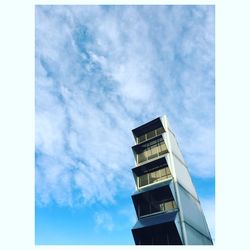 Low angle view of building against cloudy blue sky