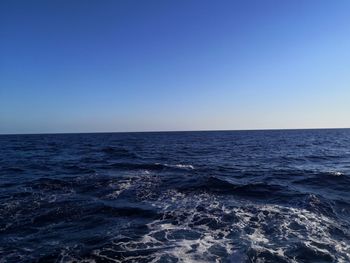 Scenic view of sea against clear blue sky