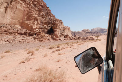 View out of car window driving through desert of wadi rum in jordan