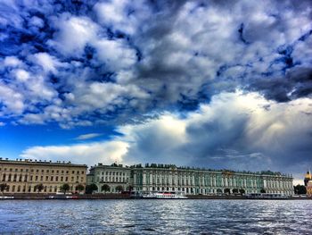 Buildings against cloudy sky