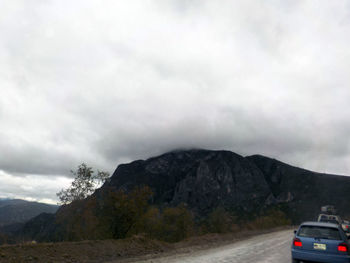 Scenic view of mountains against cloudy sky