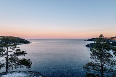 Scenic view of sea against clear sky during sunset