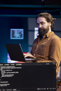 Young man using laptop at office