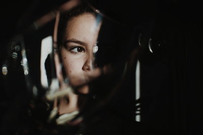 Reflection young woman in mirror while looking away