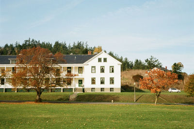 House on field against sky during autumn