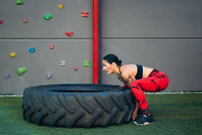 Low section of woman sitting on field