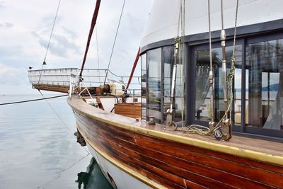 Sailboat moored in sea against sky