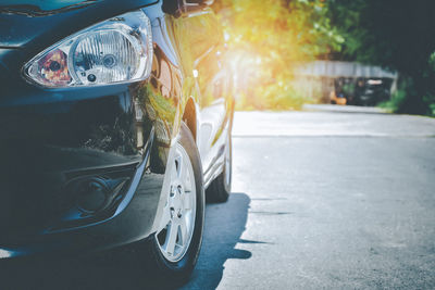 Close-up of car on road