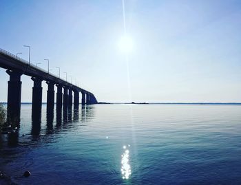 Pier over sea against clear sky