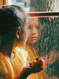 People looking through glass window