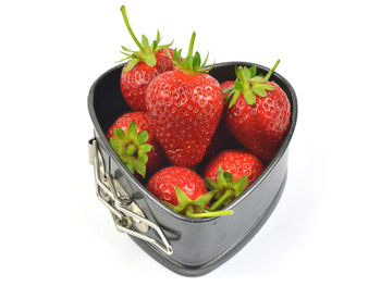 High angle view of strawberries in bowl against white background