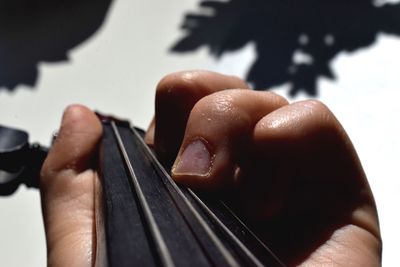 Cropped hand holding guitar