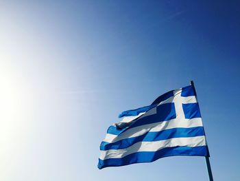 Low angle view of greek flag against sky