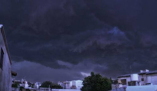 Storm clouds over city buildings