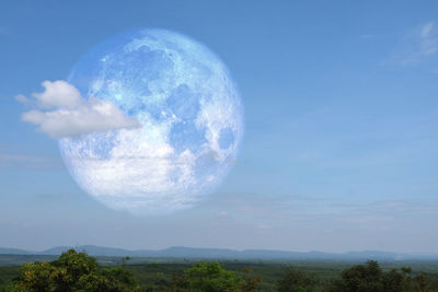Scenic view of landscape against blue sky