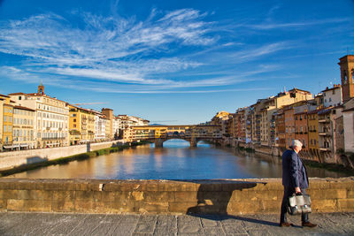 People walking on bridge over river