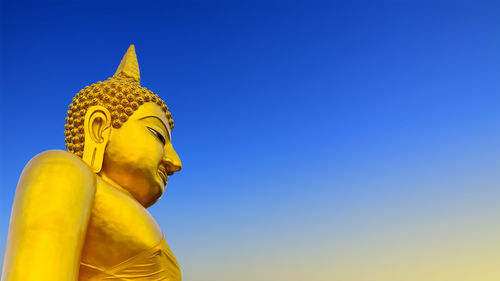 Low angle view of statue against blue sky